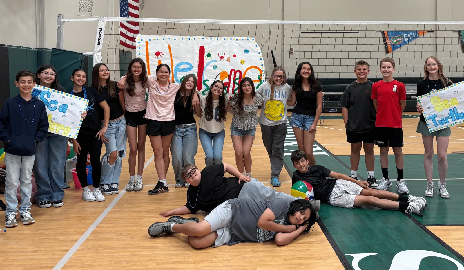 Teens tracking a food-drive donation goal on a whiteboard